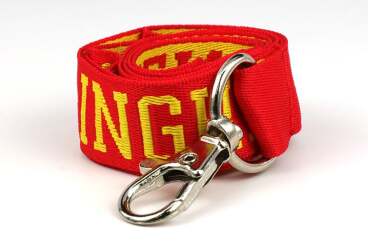 Coiled red lanyard with yellow text and a metal clip.
