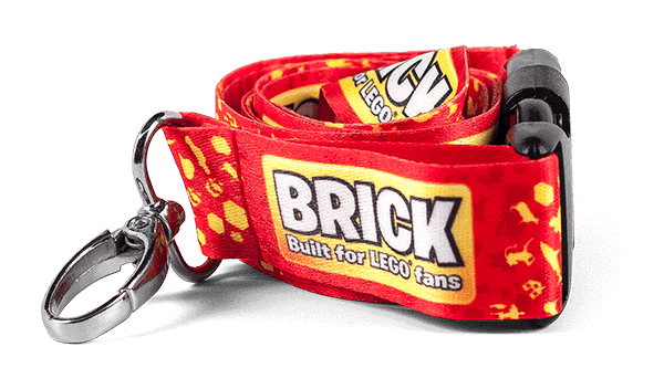 Red and yellow full color lanyard with oval hook attachment, buckle attachment and text: Brick built for Lego fans