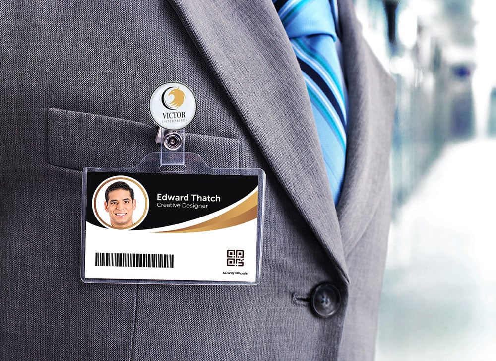 Close up of logo clip holding an employee ID, hanging from a jacket pocket