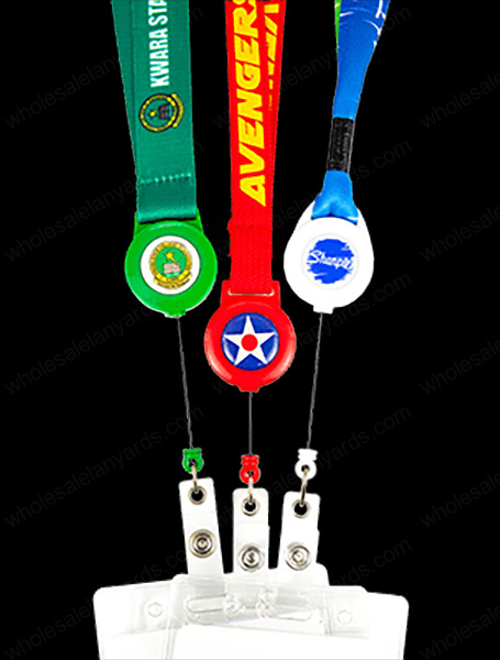 Green, red, and blue lanyards, with matching badge reels, partially extended, attached to badges
